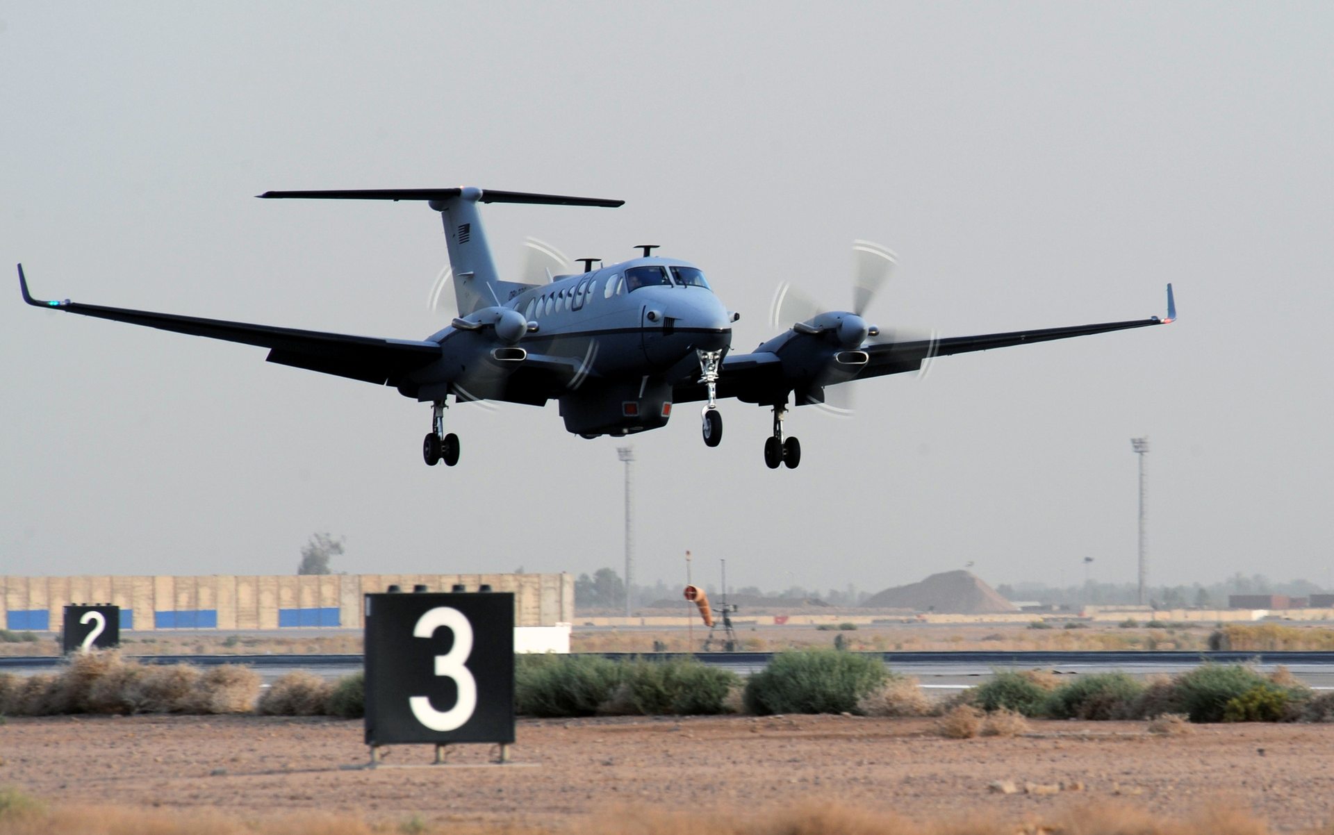 A U.S. Air Force MC-12 Liberty reconnaissance aircraft landing at Joint Base Balad, Iraq, following the type's first combat mission in 2009 — the same aircraft type, though a different specific airframe and years earlier, that recorded the 'Mosul Orb' sensor footage in 2016